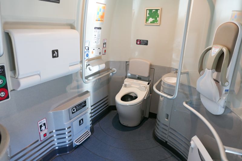 Spacious barrier-free toilet on an N700S Shinkansen, with handrails and baby-care fittings